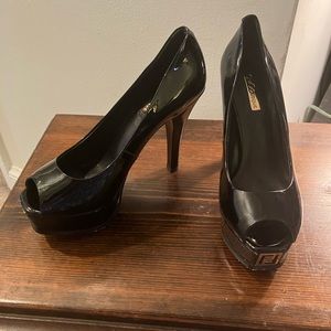Black 3.5 inch peep-toe platform stilettos, size 5.